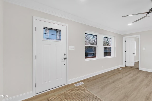 foyer entrance featuring crown molding, light hardwood / wood-style floors, and ceiling fan