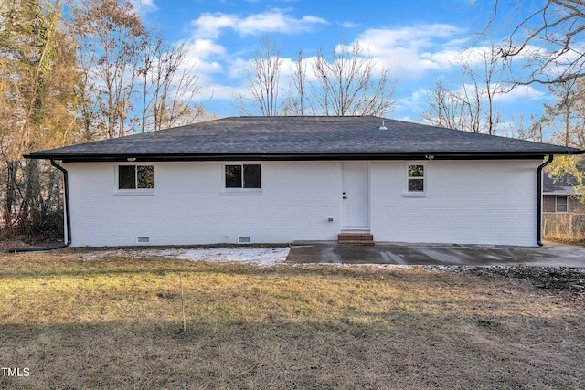 rear view of property with a patio and a yard