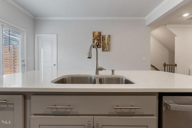 kitchen with light countertops, gray cabinets, dishwasher, ornamental molding, and a sink