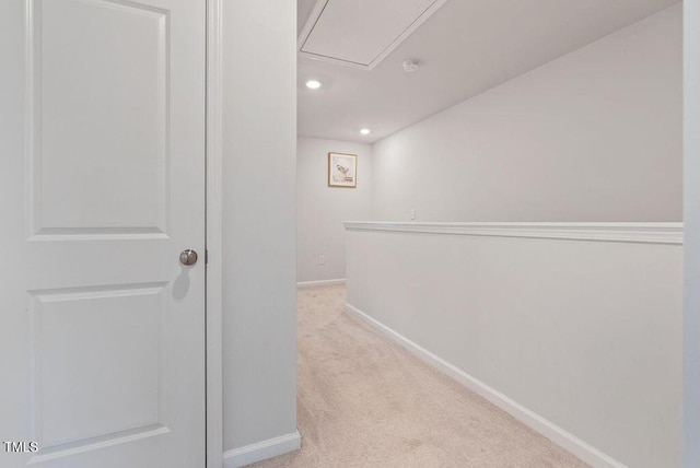 hall with baseboards, light colored carpet, recessed lighting, and attic access