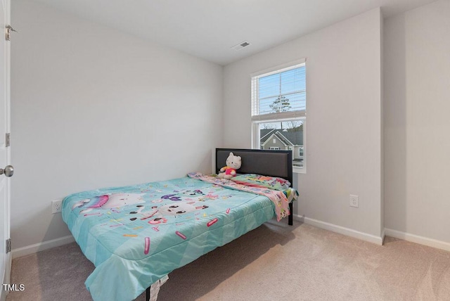 carpeted bedroom featuring baseboards and visible vents