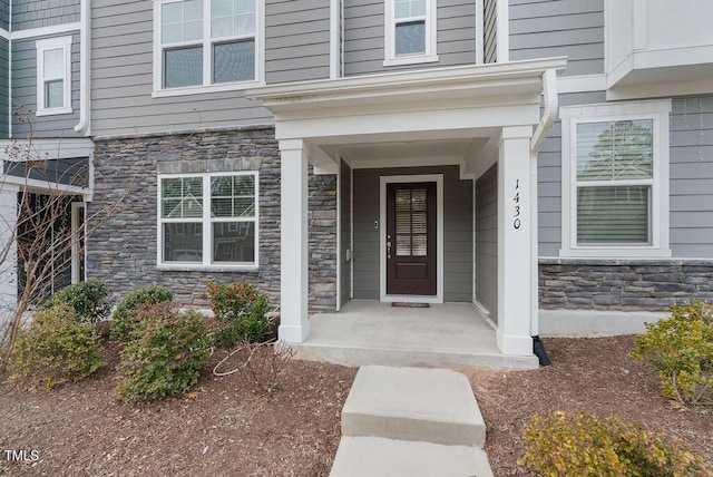 view of exterior entry featuring stone siding