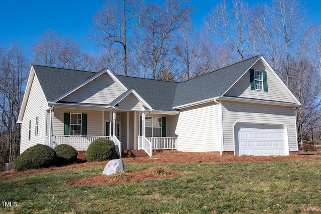 view of front of house featuring a garage, covered porch, and a front yard