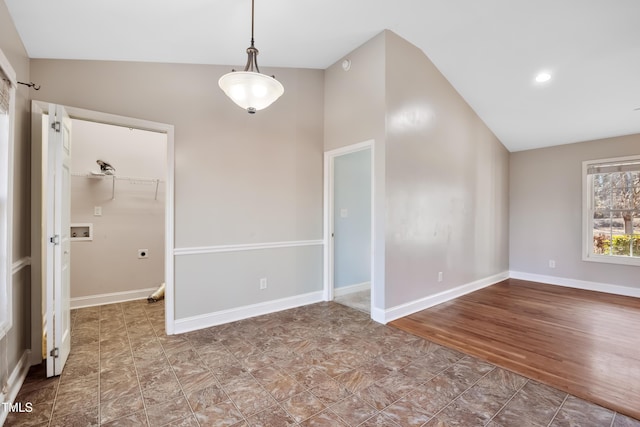 empty room featuring vaulted ceiling and hardwood / wood-style floors