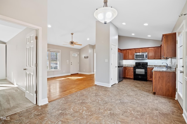 kitchen with decorative light fixtures, vaulted ceiling, ceiling fan, stainless steel appliances, and light stone countertops