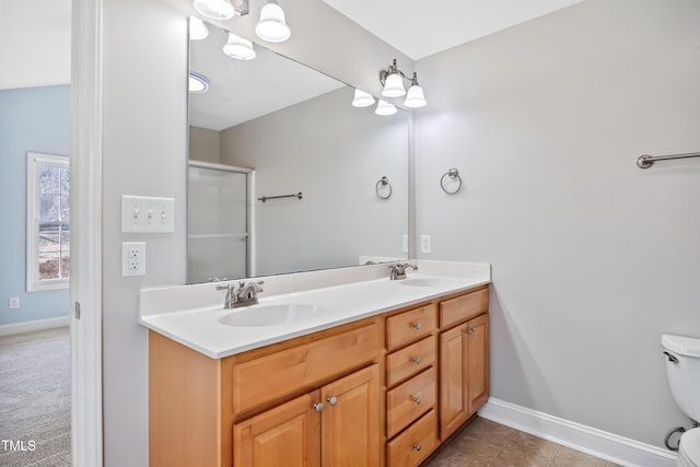 bathroom with vanity, an enclosed shower, and toilet