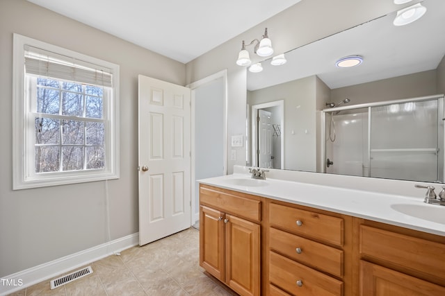 bathroom featuring vanity and an enclosed shower