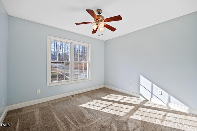 carpeted empty room featuring ceiling fan