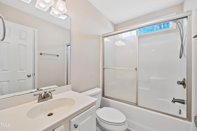 full bathroom featuring enclosed tub / shower combo, vanity, and toilet