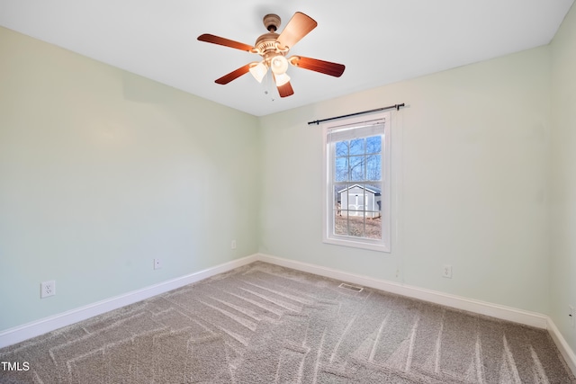 spare room featuring ceiling fan and carpet flooring