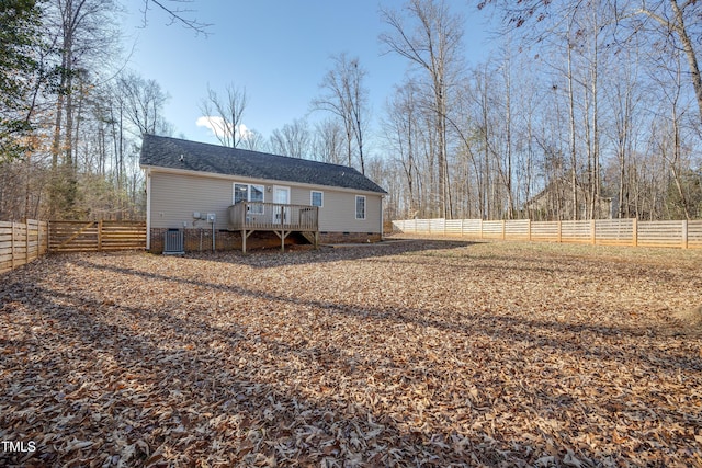 back of house with a wooden deck and central air condition unit