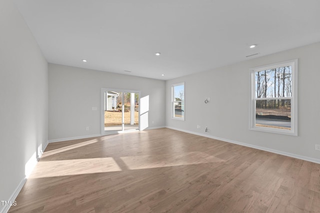 spare room with light wood-type flooring