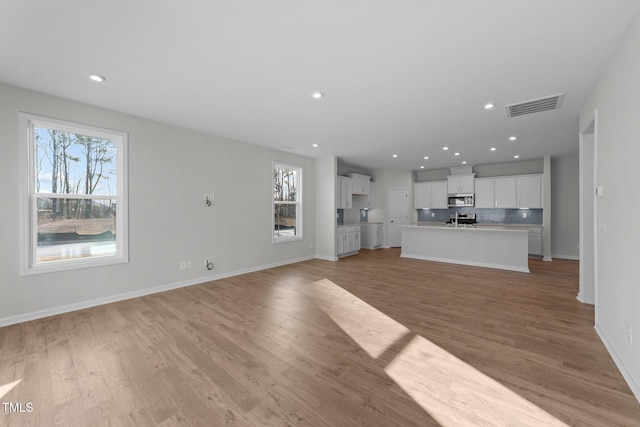 unfurnished living room with light wood-type flooring