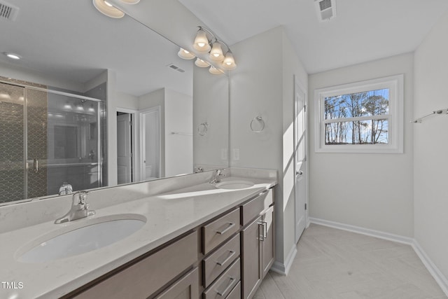 bathroom featuring vanity and a shower with door