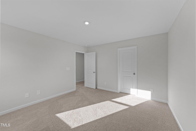 unfurnished bedroom with light colored carpet