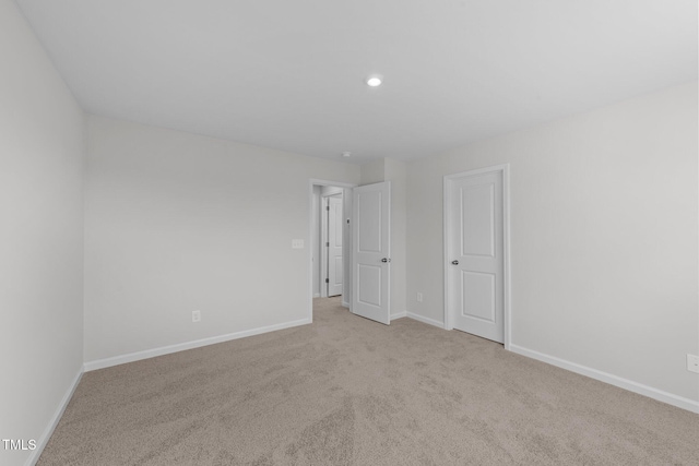 empty room with light colored carpet