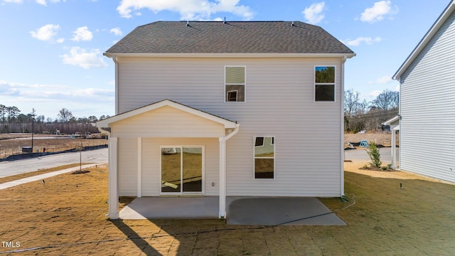 rear view of property featuring a yard and a patio