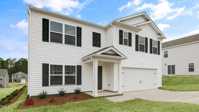 view of front of property with a garage and a front lawn