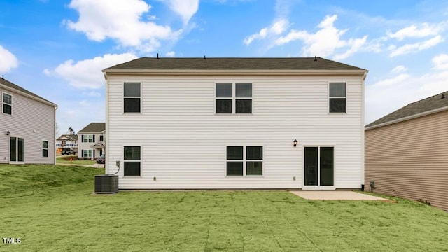 back of house with a lawn and a patio area