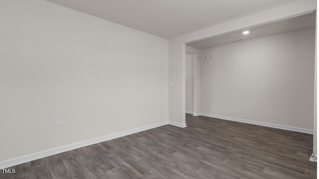 empty room with dark wood-type flooring