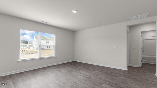 empty room with dark hardwood / wood-style floors