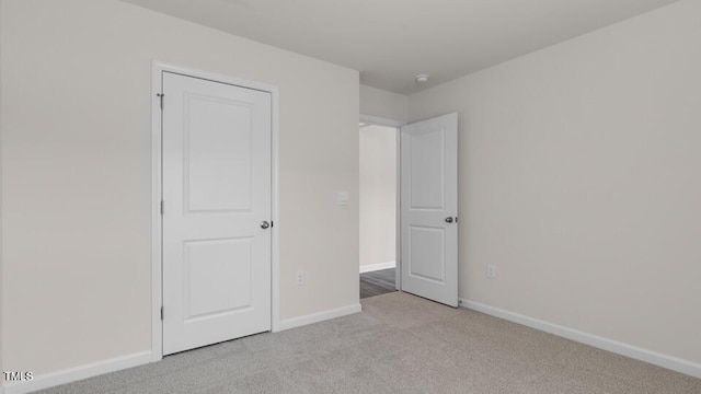 unfurnished bedroom with light colored carpet