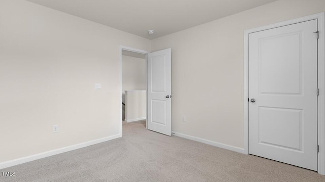 unfurnished bedroom featuring light colored carpet