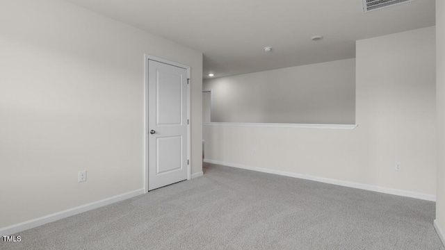 unfurnished room featuring light colored carpet