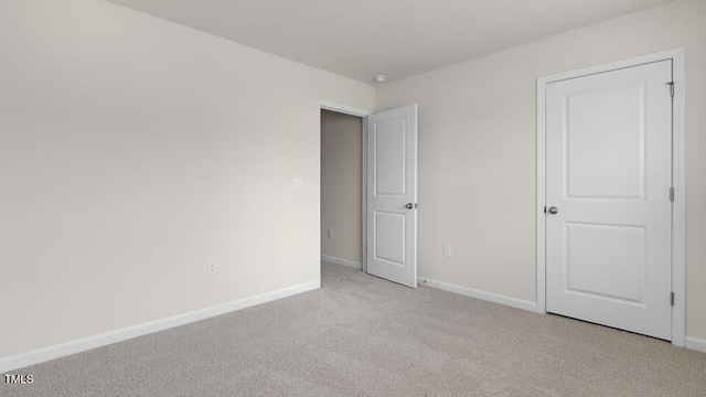 unfurnished bedroom with light colored carpet