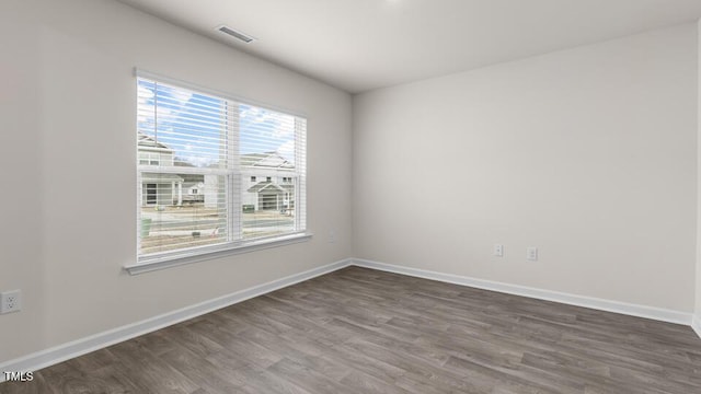 spare room with dark hardwood / wood-style flooring