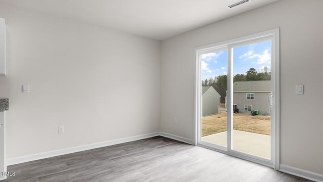 spare room with wood-type flooring