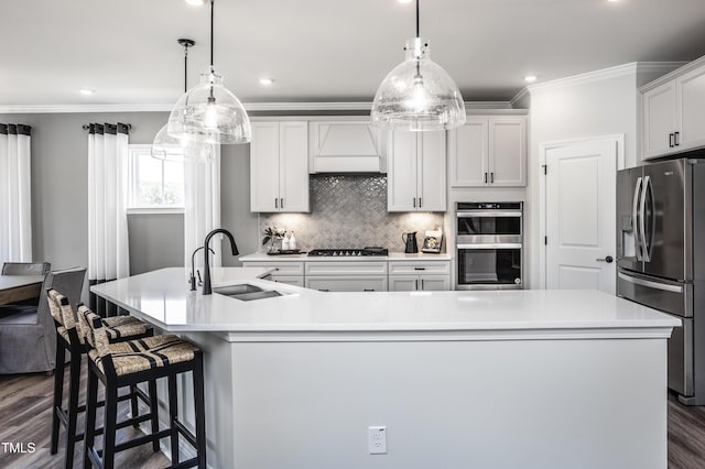 kitchen featuring sink, stainless steel appliances, hanging light fixtures, and a spacious island