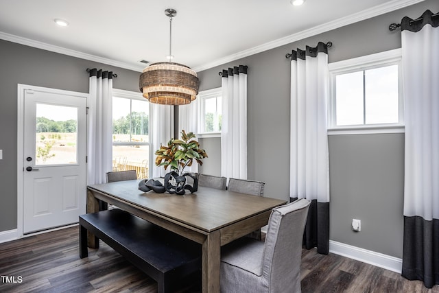 dining area with ornamental molding and dark wood-type flooring