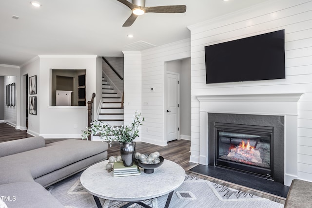 living room with ornamental molding, ceiling fan, and dark hardwood / wood-style flooring