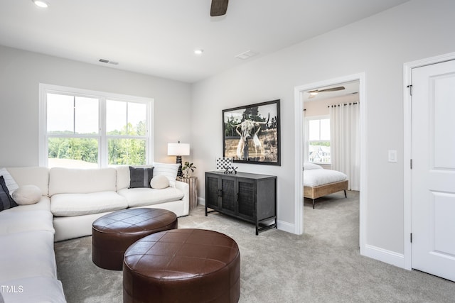 living room featuring light carpet and ceiling fan