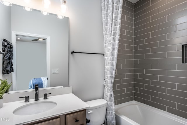 full bathroom featuring vanity, shower / bath combination with curtain, and toilet