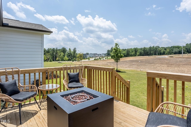 deck featuring a yard and a fire pit