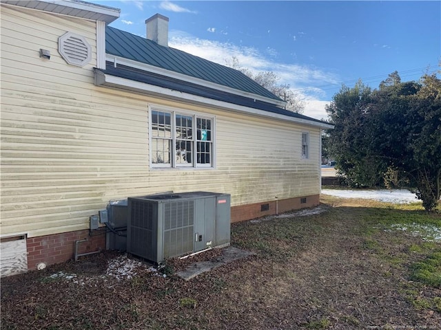 view of side of property featuring central AC