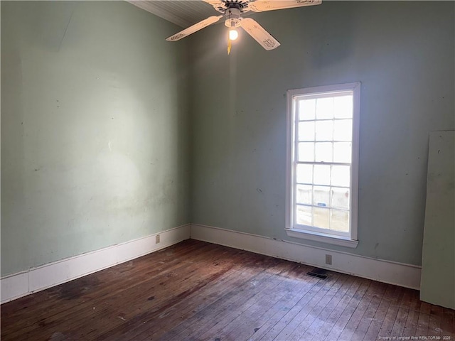 unfurnished room with ceiling fan and dark hardwood / wood-style flooring