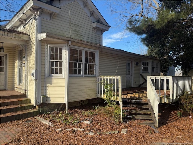 view of side of home with a deck