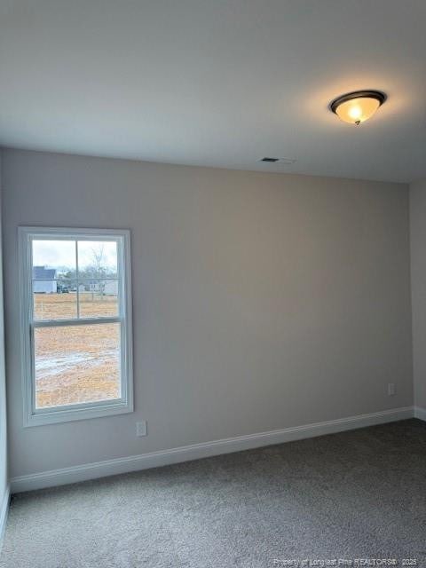 carpeted empty room with visible vents and baseboards