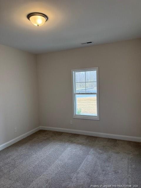 empty room featuring baseboards, visible vents, and carpet flooring