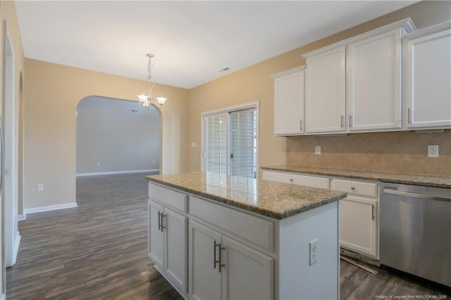 kitchen with dishwasher, hanging light fixtures, a kitchen island, and white cabinets