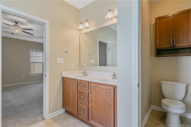 bathroom featuring vanity, tile patterned floors, ceiling fan, and toilet