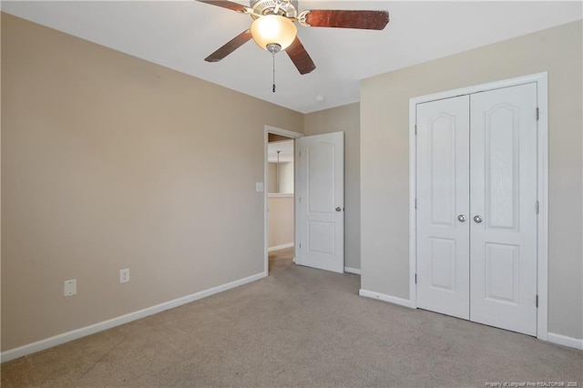 unfurnished bedroom with light carpet, a closet, and ceiling fan