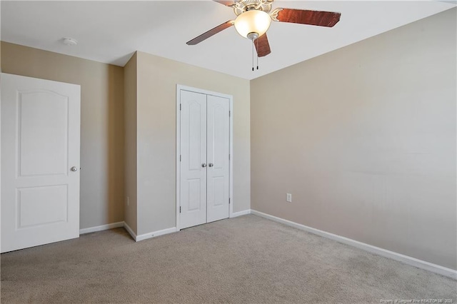 unfurnished bedroom with light colored carpet, a closet, and ceiling fan