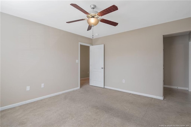 carpeted spare room with ceiling fan