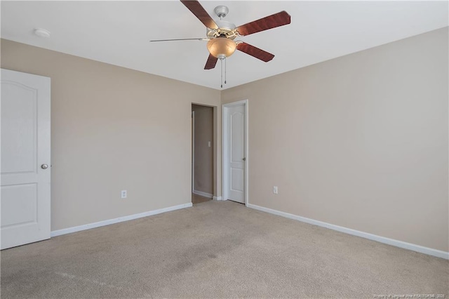 carpeted empty room featuring ceiling fan