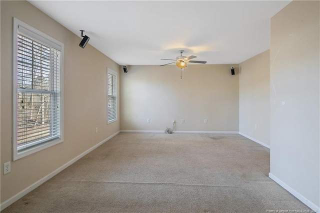 spare room featuring ceiling fan and light colored carpet