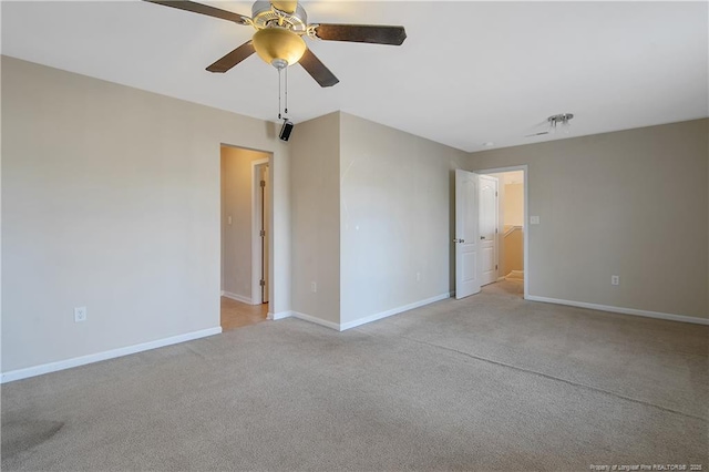 carpeted empty room featuring ceiling fan